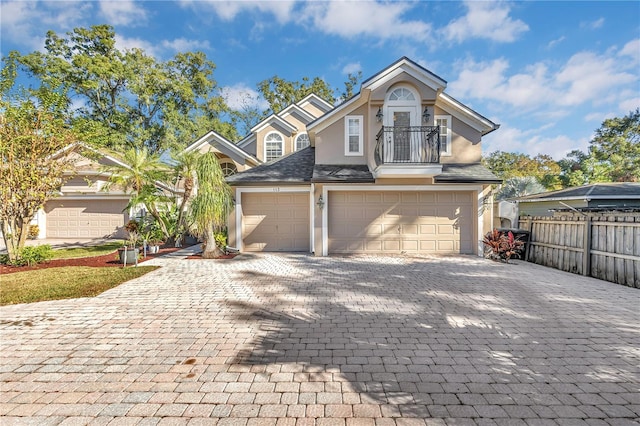 front of property with a balcony and a garage