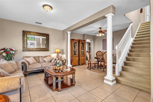 tiled living room with ornate columns and ceiling fan