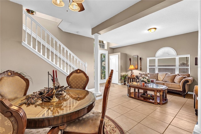 tiled living room with ornate columns and ceiling fan