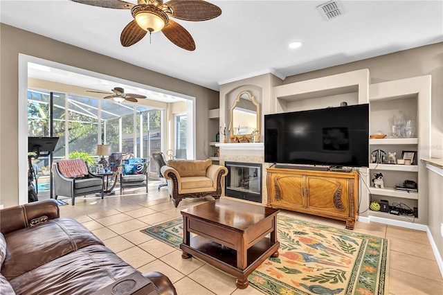 living room with built in features, crown molding, and light tile patterned flooring