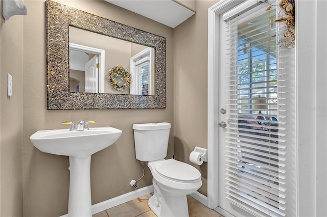 bathroom with tile patterned flooring, toilet, and sink