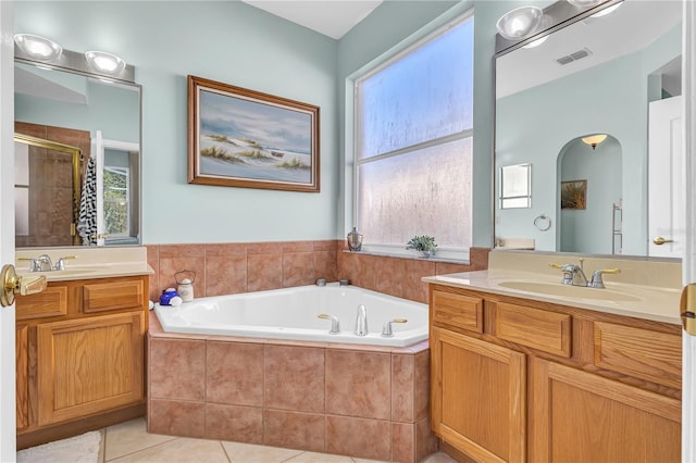 bathroom featuring vanity, tile patterned floors, and separate shower and tub