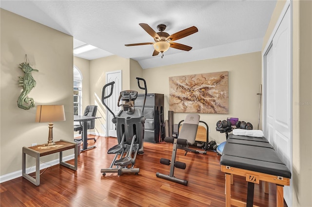 exercise area featuring ceiling fan, hardwood / wood-style floors, and a textured ceiling