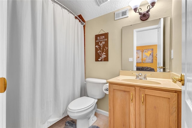 bathroom featuring tile patterned flooring, vanity, toilet, and a textured ceiling