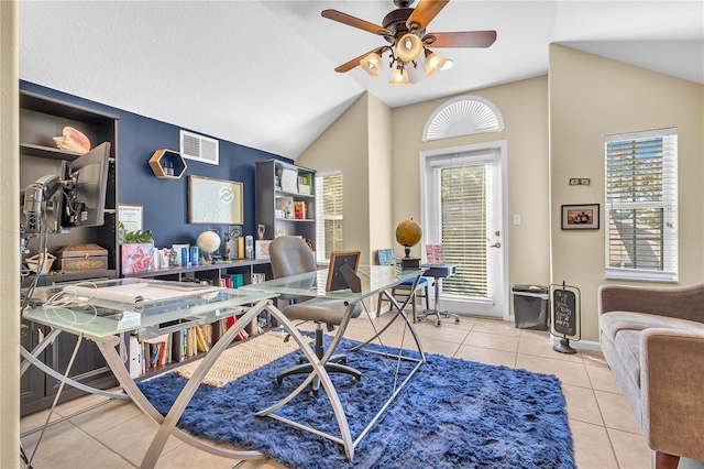 tiled office featuring ceiling fan, plenty of natural light, and vaulted ceiling