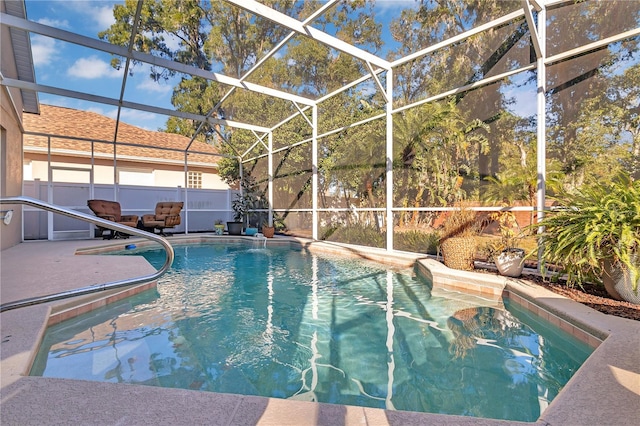 view of swimming pool with a patio area and glass enclosure