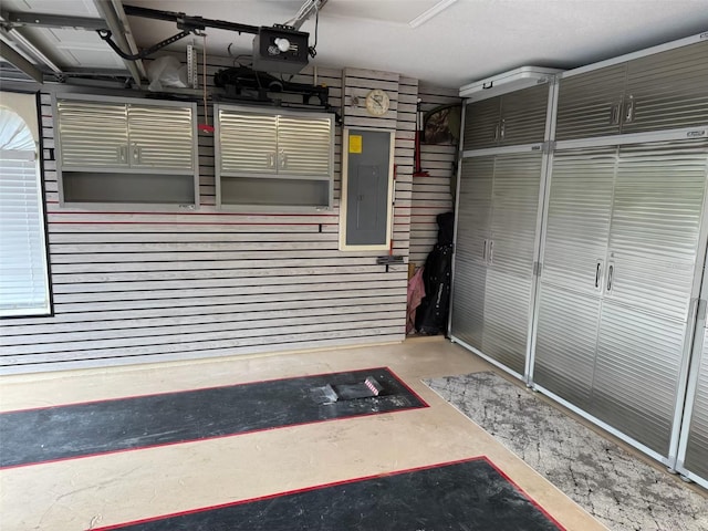 garage featuring electric panel and a garage door opener