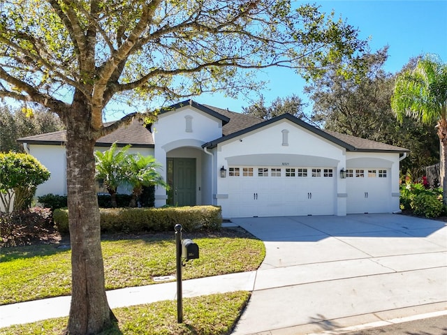 view of front of home featuring a garage and a front lawn