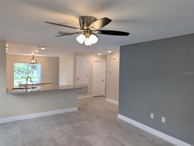 interior space featuring ceiling fan and sink