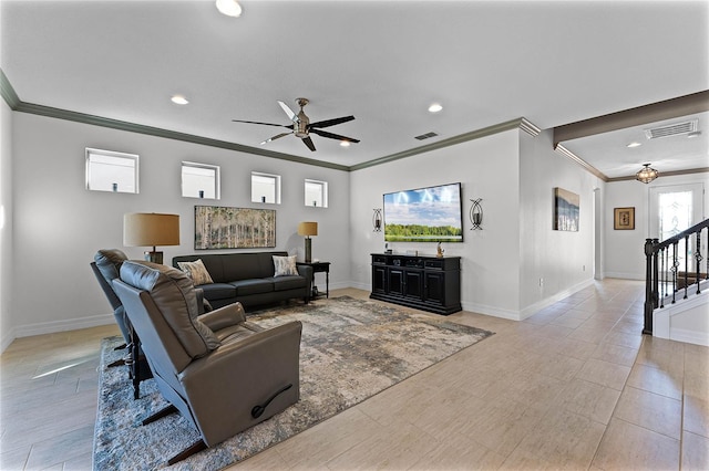 living area with ceiling fan, visible vents, crown molding, and stairs