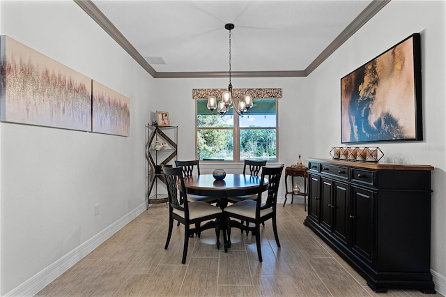 dining room featuring ornamental molding, a chandelier, visible vents, and baseboards