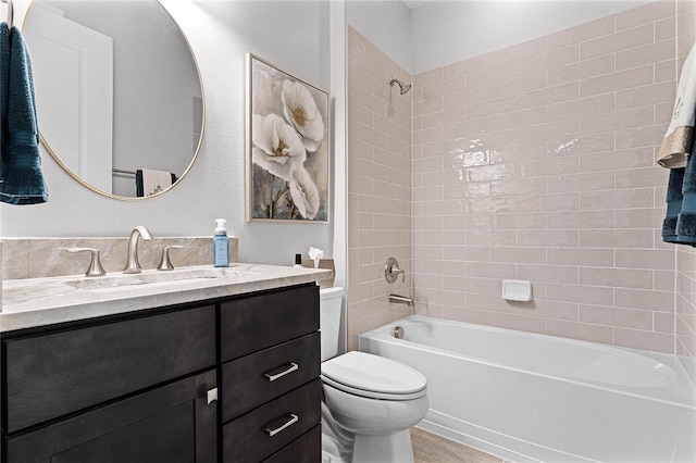 bathroom featuring  shower combination, vanity, toilet, and wood finished floors