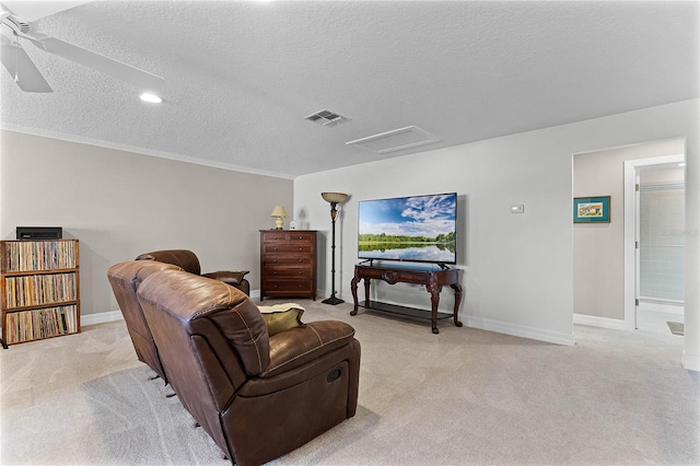 interior space featuring attic access, baseboards, visible vents, light colored carpet, and a textured ceiling