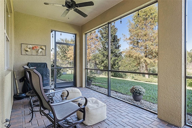 sunroom featuring a ceiling fan