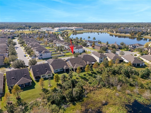 drone / aerial view featuring a water view and a residential view