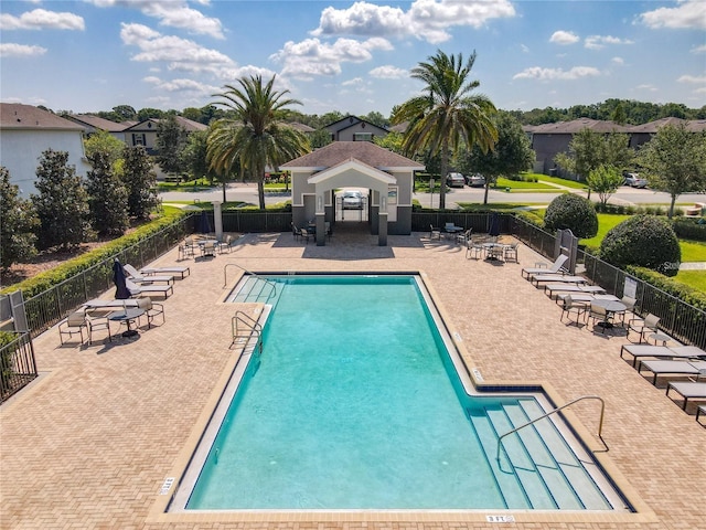 pool with fence and a patio