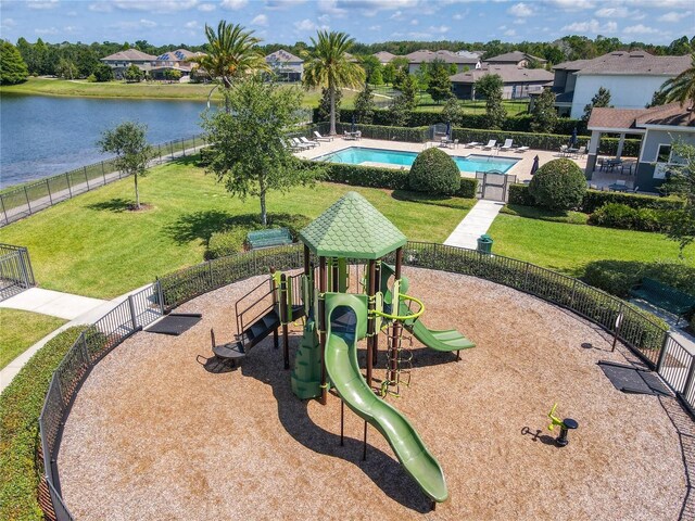 view of property's community with a swimming pool, fence, playground community, and a yard