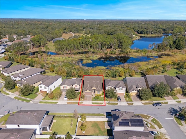 birds eye view of property featuring a residential view, a water view, and a view of trees