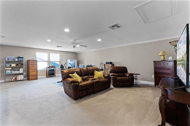 interior space with light colored carpet, visible vents, attic access, a textured ceiling, and baseboards