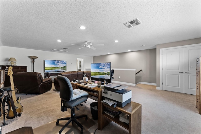 office space featuring recessed lighting, visible vents, light carpet, a textured ceiling, and baseboards