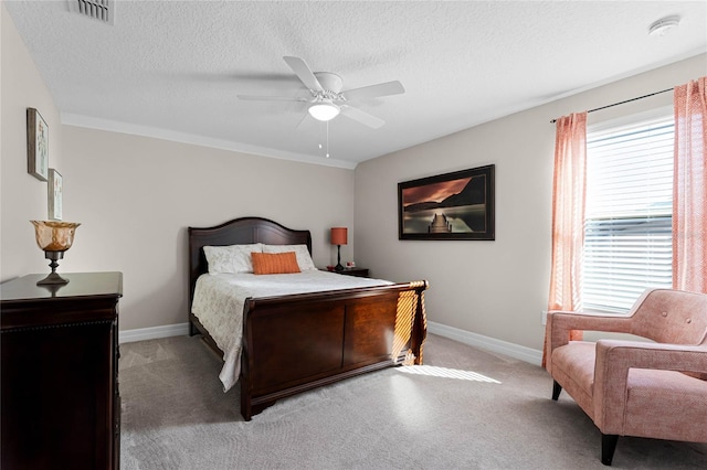 bedroom featuring baseboards, visible vents, ceiling fan, and a textured ceiling