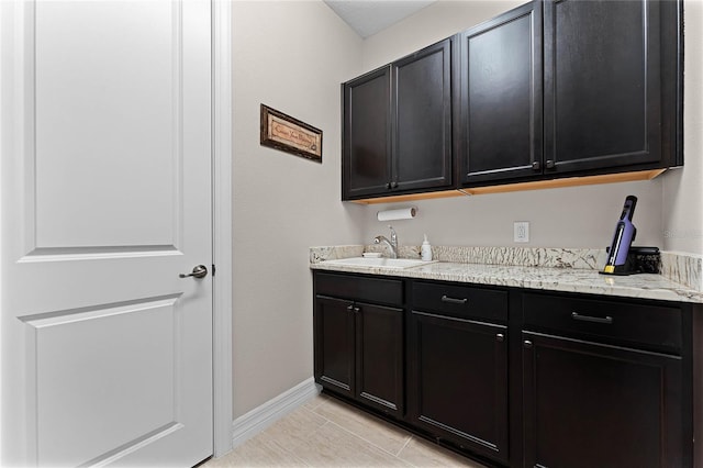 interior space featuring a sink and baseboards