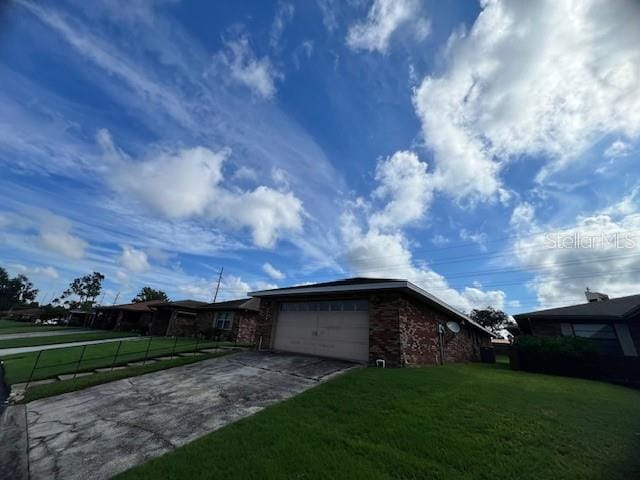 view of side of home with a yard and a garage