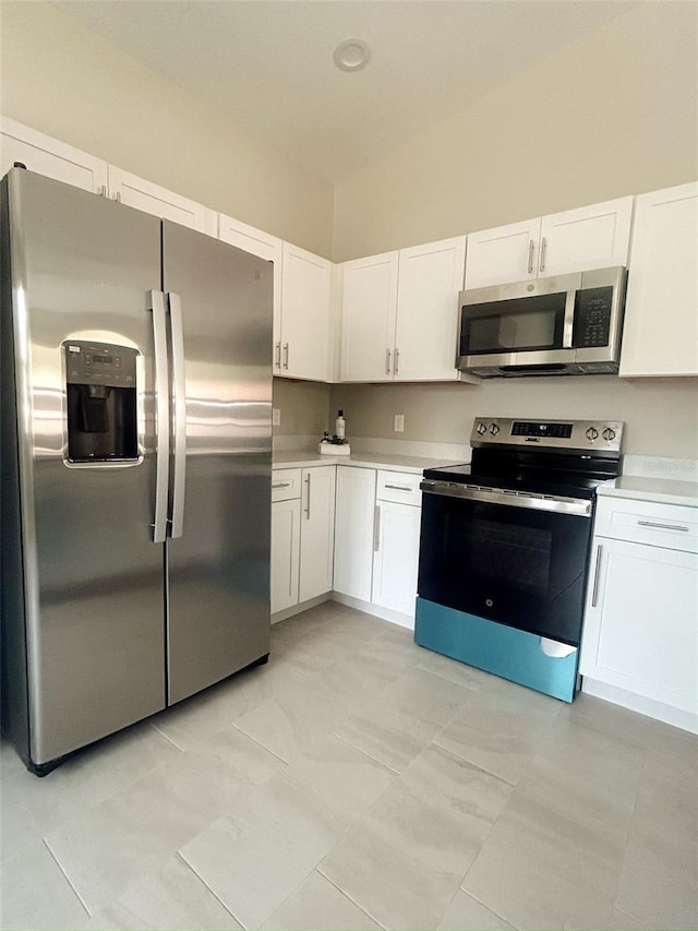 kitchen featuring light countertops, appliances with stainless steel finishes, and white cabinetry