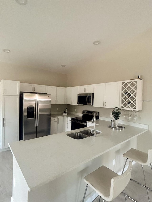 kitchen with light countertops, appliances with stainless steel finishes, and white cabinets