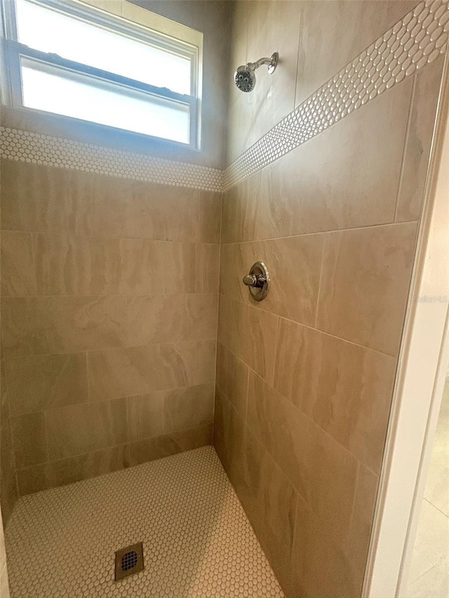 full bath featuring tiled shower