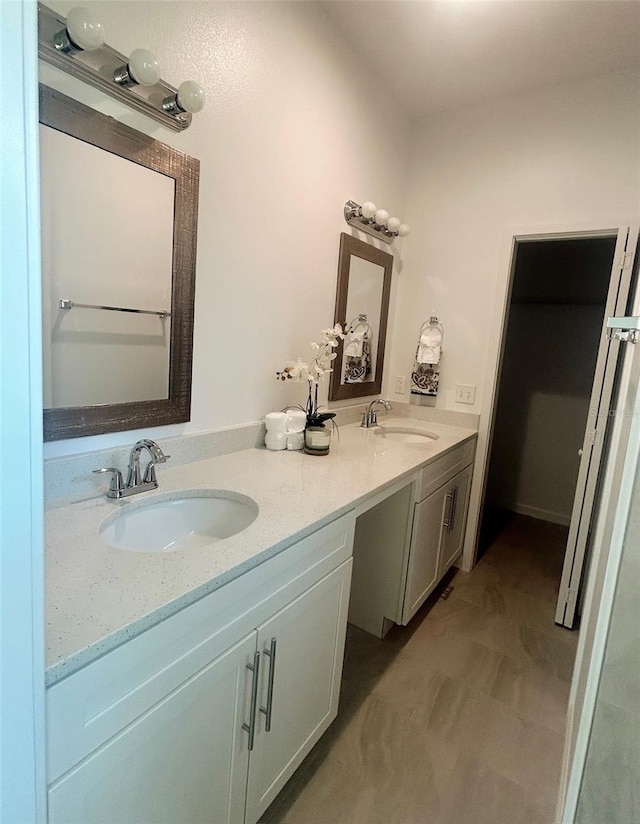 full bathroom with double vanity and a sink