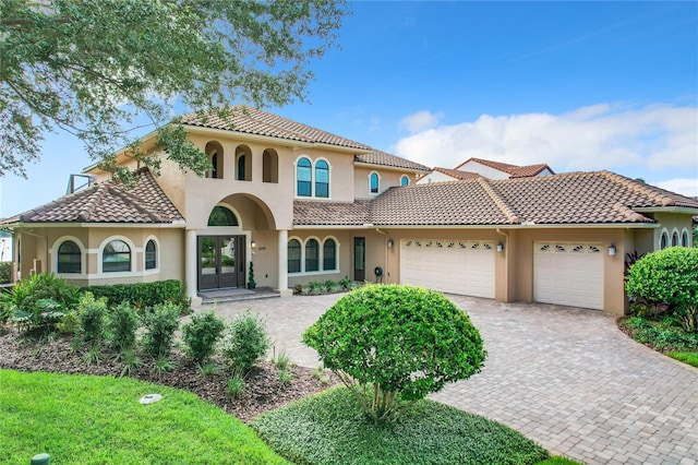 mediterranean / spanish-style house with a garage