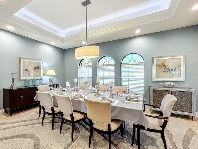 dining room with a raised ceiling