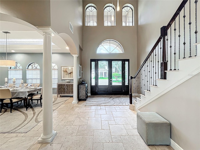 foyer entrance featuring french doors and a towering ceiling