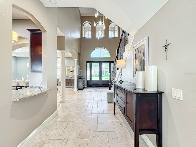 foyer featuring french doors and ornate columns