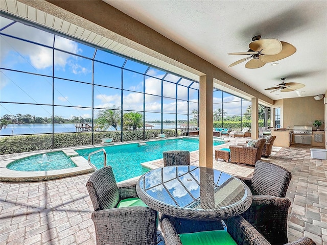 view of pool featuring outdoor lounge area, ceiling fan, an outdoor kitchen, a patio area, and a water view