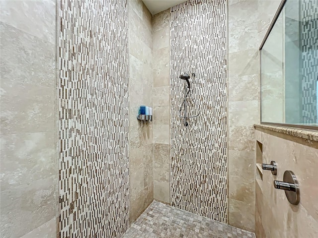 bathroom with a tile shower