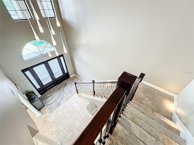 foyer with a high ceiling, hardwood / wood-style flooring, and french doors