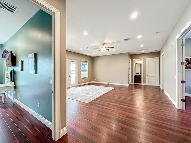 unfurnished living room with ceiling fan and dark hardwood / wood-style floors