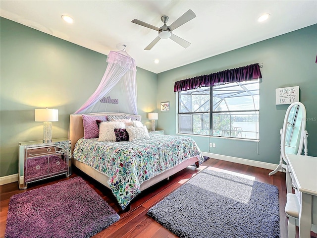 bedroom with ceiling fan and dark wood-type flooring