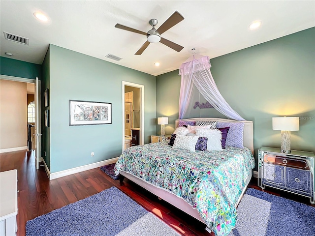 bedroom with ceiling fan, ensuite bathroom, and dark wood-type flooring