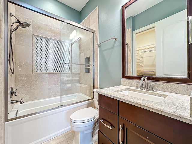 full bathroom with tile patterned floors, vanity, toilet, and enclosed tub / shower combo