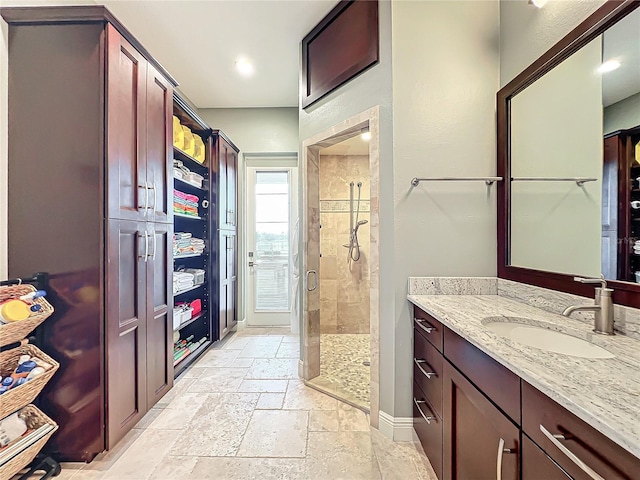 bathroom featuring vanity and a shower with shower door