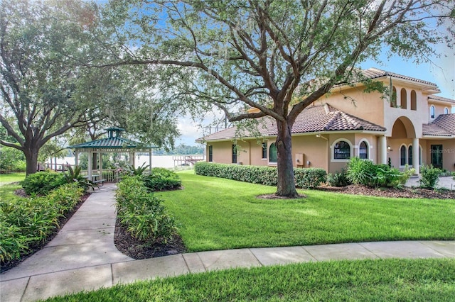 view of front facade featuring a gazebo and a front yard