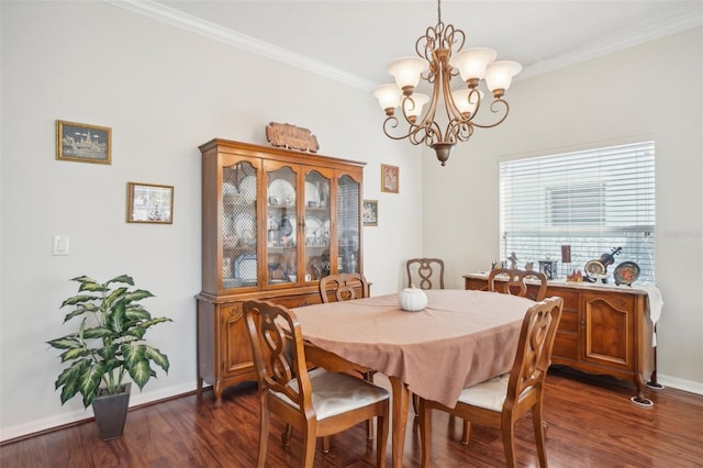 dining space featuring dark hardwood / wood-style flooring, crown molding, and a chandelier