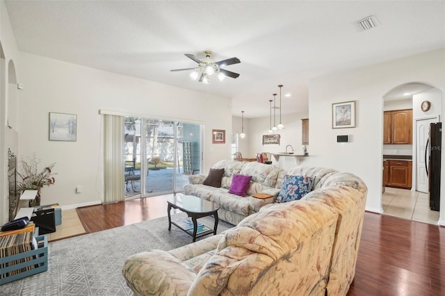 living room featuring ceiling fan and light hardwood / wood-style floors