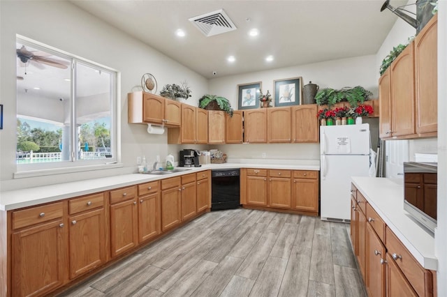 kitchen with light wood-type flooring, ceiling fan, sink, dishwasher, and white fridge