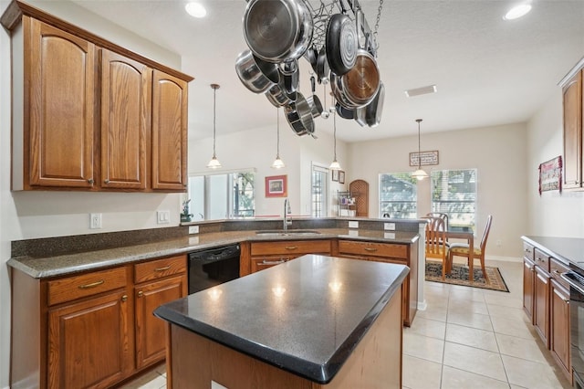 kitchen with black dishwasher, a center island, hanging light fixtures, and sink