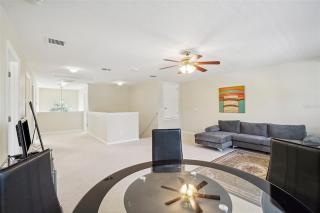 carpeted living room featuring ceiling fan