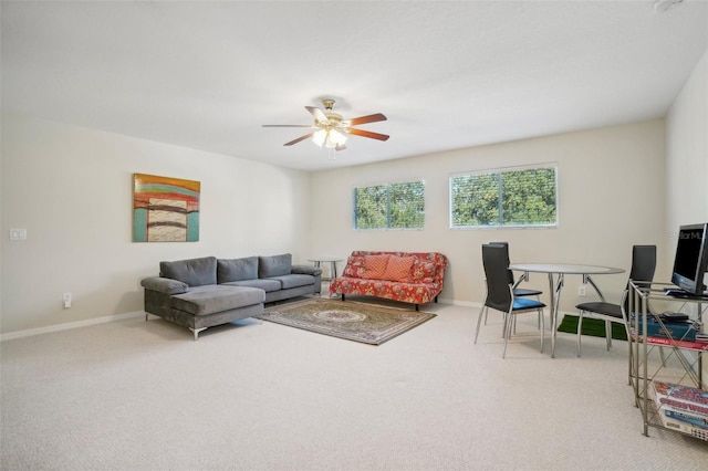 carpeted living room with ceiling fan